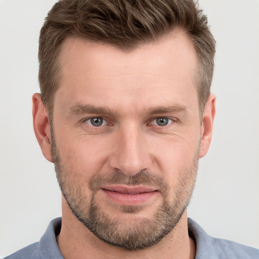 Joyful white adult male with short  brown hair and grey eyes