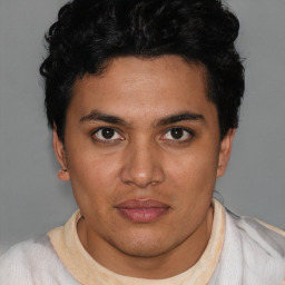 Joyful latino young-adult male with short  brown hair and brown eyes