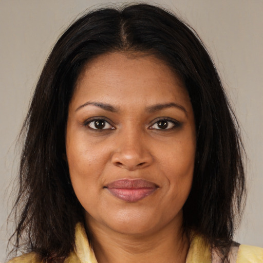 Joyful black young-adult female with medium  brown hair and brown eyes