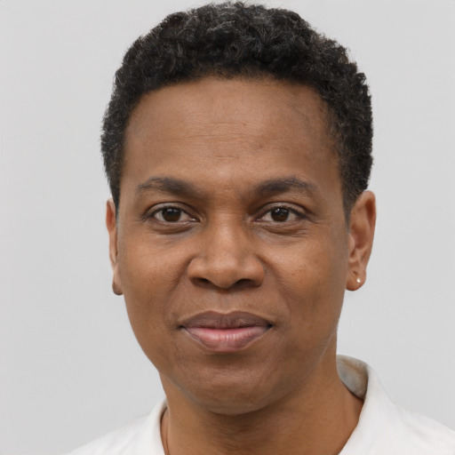Joyful black adult male with short  black hair and brown eyes