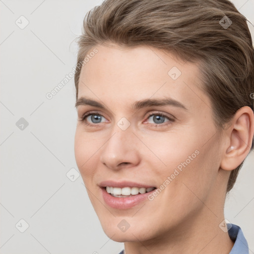 Joyful white young-adult female with short  brown hair and grey eyes