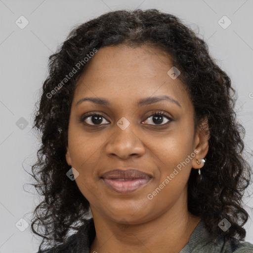 Joyful black young-adult female with long  brown hair and brown eyes