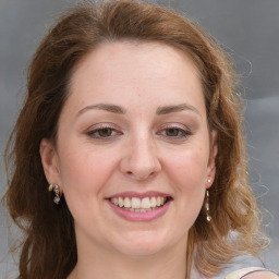 Joyful white young-adult female with long  brown hair and blue eyes