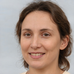 Joyful white adult female with medium  brown hair and brown eyes