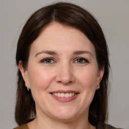 Joyful white adult female with medium  brown hair and brown eyes