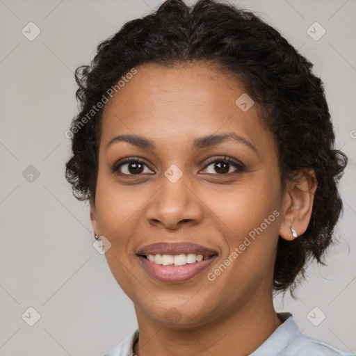 Joyful black young-adult female with short  brown hair and brown eyes