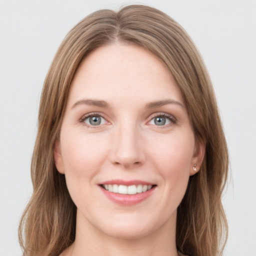 Joyful white young-adult female with long  brown hair and green eyes