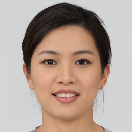 Joyful asian young-adult female with medium  brown hair and brown eyes