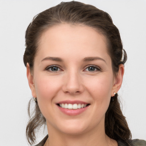 Joyful white young-adult female with medium  brown hair and grey eyes