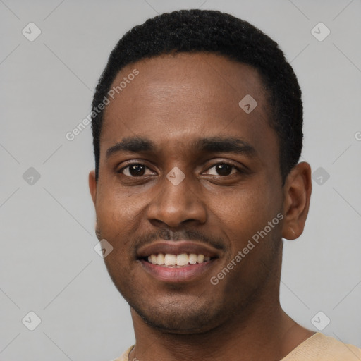 Joyful black young-adult male with short  black hair and brown eyes