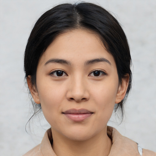 Joyful latino young-adult female with medium  brown hair and brown eyes