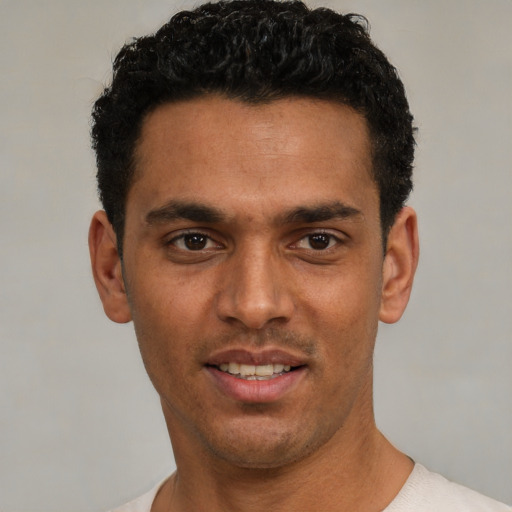 Joyful white young-adult male with short  black hair and brown eyes