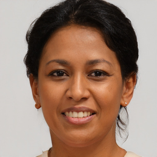 Joyful black young-adult female with medium  brown hair and brown eyes