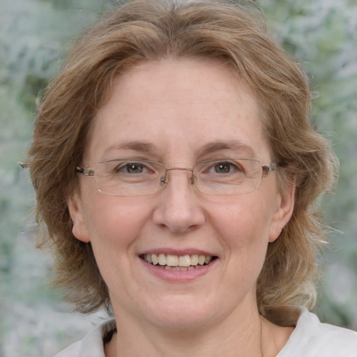 Joyful white adult female with medium  brown hair and blue eyes