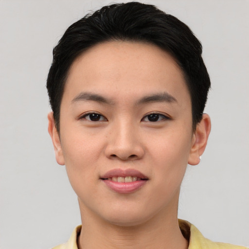Joyful asian young-adult male with short  brown hair and brown eyes