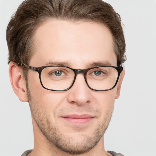 Joyful white adult male with short  brown hair and grey eyes