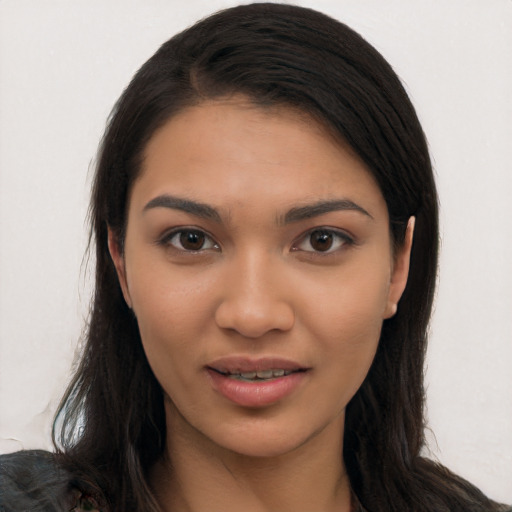 Joyful latino young-adult female with long  brown hair and brown eyes