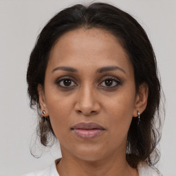 Joyful black adult female with medium  brown hair and brown eyes