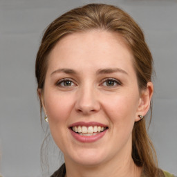 Joyful white young-adult female with medium  brown hair and grey eyes