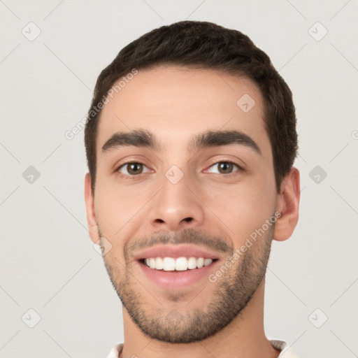 Joyful white young-adult male with short  black hair and brown eyes