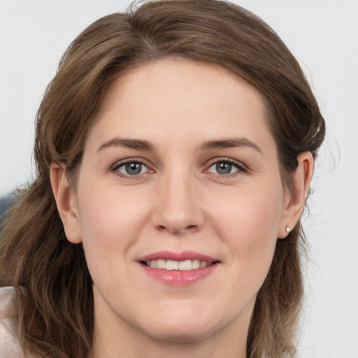 Joyful white young-adult female with medium  brown hair and grey eyes