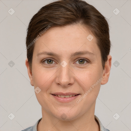 Joyful white adult female with short  brown hair and grey eyes