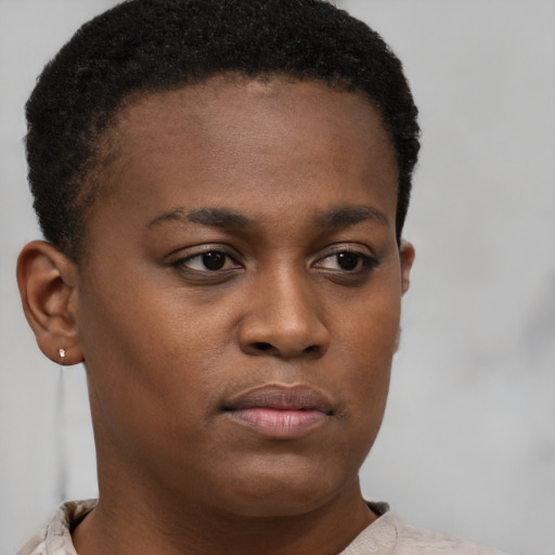 Joyful black young-adult female with short  brown hair and brown eyes