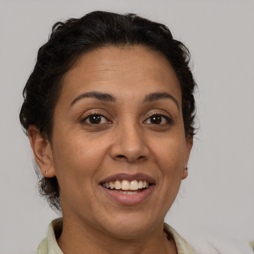 Joyful white adult female with short  brown hair and brown eyes