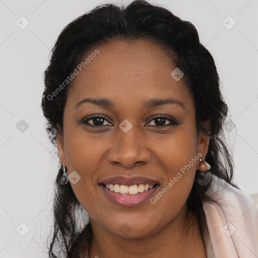 Joyful black young-adult female with long  brown hair and brown eyes