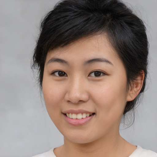 Joyful asian young-adult female with medium  brown hair and brown eyes
