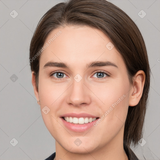 Joyful white young-adult female with medium  brown hair and grey eyes