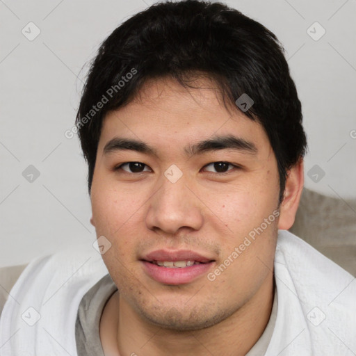 Joyful asian young-adult male with short  brown hair and brown eyes