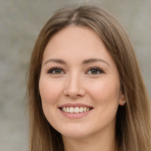 Joyful white young-adult female with long  brown hair and brown eyes