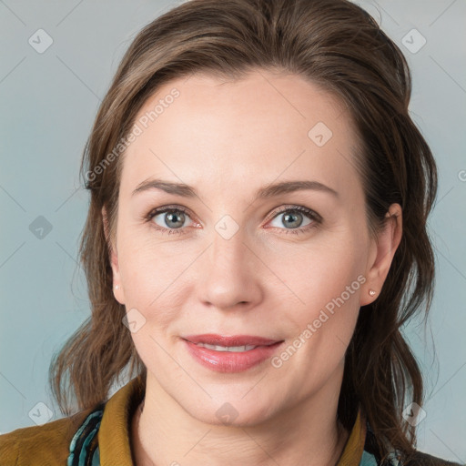 Joyful white young-adult female with medium  brown hair and blue eyes