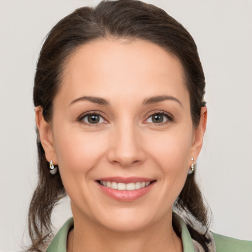 Joyful white young-adult female with medium  brown hair and brown eyes