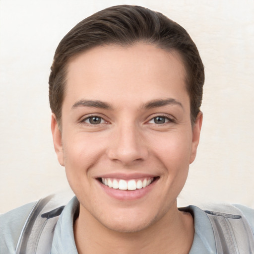 Joyful white young-adult female with short  brown hair and brown eyes