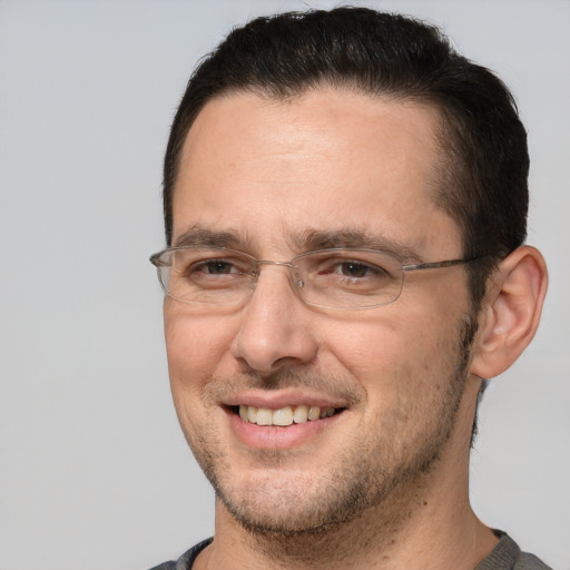 Joyful white adult male with short  brown hair and brown eyes