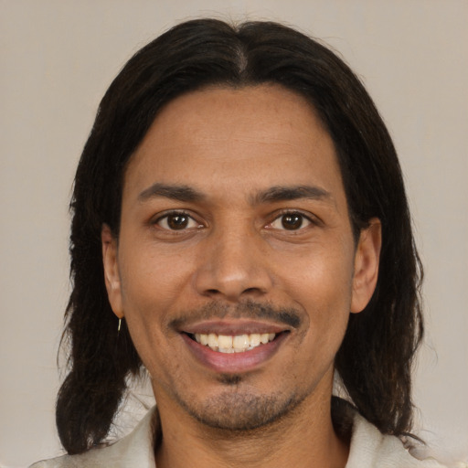 Joyful black young-adult male with medium  brown hair and brown eyes
