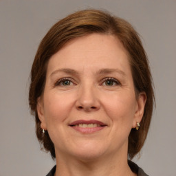 Joyful white adult female with medium  brown hair and grey eyes