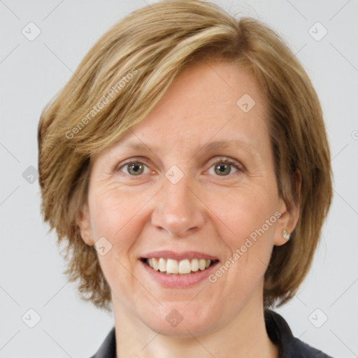 Joyful white adult female with medium  brown hair and grey eyes