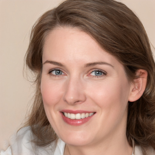 Joyful white young-adult female with medium  brown hair and blue eyes