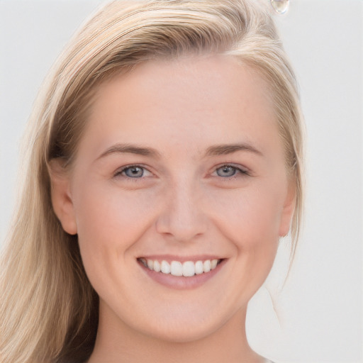 Joyful white young-adult female with long  brown hair and blue eyes