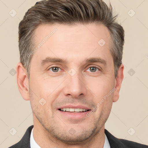 Joyful white adult male with short  brown hair and brown eyes