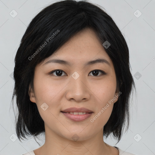 Joyful asian young-adult female with medium  black hair and brown eyes