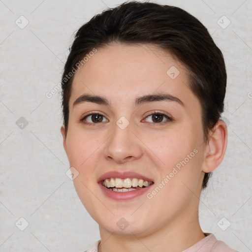 Joyful white young-adult female with short  brown hair and brown eyes