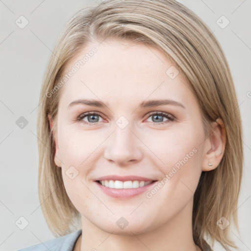 Joyful white young-adult female with medium  brown hair and blue eyes