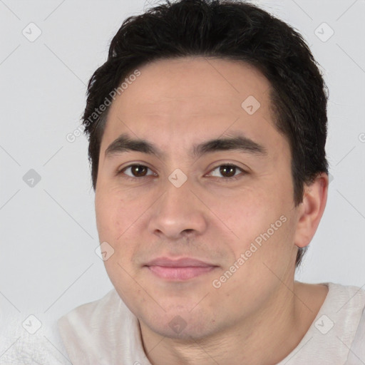 Joyful white young-adult male with short  black hair and brown eyes