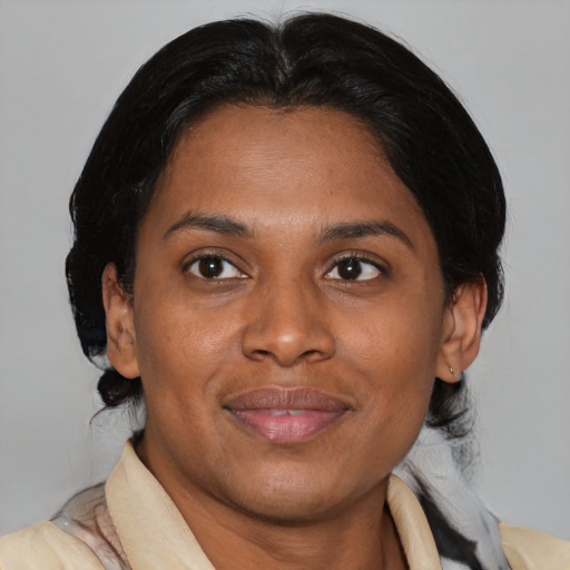 Joyful latino adult female with medium  brown hair and brown eyes