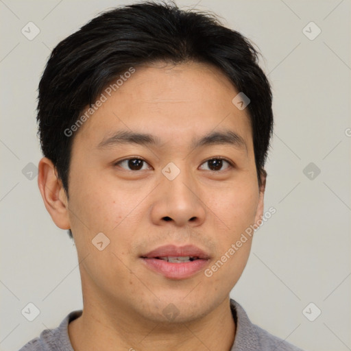 Joyful asian young-adult male with short  black hair and brown eyes