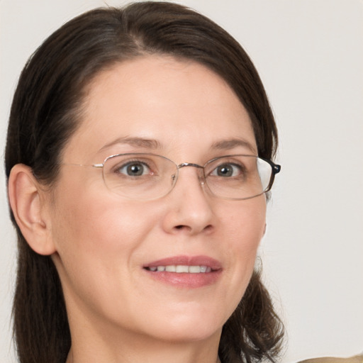 Joyful white adult female with medium  brown hair and grey eyes